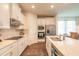 Modern kitchen with white cabinets, stainless steel appliances, and a kitchen island at 2836 Monaghan Dr, Ormond Beach, FL 32174