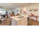 Kitchen island with a double sink, stainless steel dishwasher, and wood-look ceramic tile flooring at 2836 Monaghan Dr, Ormond Beach, FL 32174