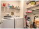 Laundry room featuring updated appliances and storage shelving at 2836 Monaghan Dr, Ormond Beach, FL 32174