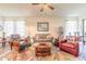 Inviting living room with stylish furnishings, ceiling fan, and abundant natural light from large windows at 2836 Monaghan Dr, Ormond Beach, FL 32174
