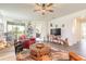 Spacious living room with a ceiling fan, leather furniture, and access to the lanai at 2836 Monaghan Dr, Ormond Beach, FL 32174