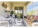 Covered patio with elegant decor, furniture, and sliding glass doors at 2836 Monaghan Dr, Ormond Beach, FL 32174