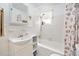 A bright bathroom with a shower-tub combo with seashell curtain and fixtures at 918 N Wild Olive Ave, Daytona Beach, FL 32118
