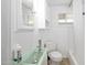 Compact bathroom with a unique sink, ample lighting, and neutral decor at 918 N Wild Olive Ave, Daytona Beach, FL 32118