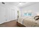Spacious bedroom with a ceiling fan, closet, and windows providing natural light at 918 N Wild Olive Ave, Daytona Beach, FL 32118