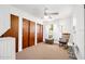 Bright bedroom with wood sliding closet doors, ceiling fan, and rocking chair at 918 N Wild Olive Ave, Daytona Beach, FL 32118