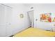 Bright bedroom featuring a closet, artwork, and yellow bedding at 918 N Wild Olive Ave, Daytona Beach, FL 32118