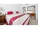 Cozy bedroom with a comfortable bed, wooden dresser, and a mirrored door at 918 N Wild Olive Ave, Daytona Beach, FL 32118