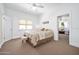 Well-lit bedroom with a queen-sized bed, windows, and neutral decor at 918 N Wild Olive Ave, Daytona Beach, FL 32118