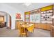 Bright dining room features custom built-in bookshelves, a vintage hutch and a charming drop-leaf dining table at 918 N Wild Olive Ave, Daytona Beach, FL 32118