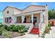 Charming single-story home featuring a beautiful red tile roof, covered porch with white curtains, and landscaping at 918 N Wild Olive Ave, Daytona Beach, FL 32118