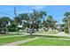 Charming home with a lush front yard and mature trees, creating a welcoming and serene atmosphere at 918 N Wild Olive Ave, Daytona Beach, FL 32118