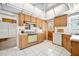 Cozy kitchen featuring wood cabinets, tile flooring, and a vintage light green oven at 918 N Wild Olive Ave, Daytona Beach, FL 32118