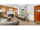Inviting living room featuring a brick fireplace, woven furniture, and wood paneling at 918 N Wild Olive Ave, Daytona Beach, FL 32118