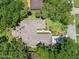Aerial view of the home showing the roof, driveway, and surrounding greenery at 1108 Northside Dr, Ormond Beach, FL 32174
