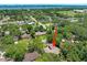 Aerial view of the home with a water view and lush green trees surrounding it at 1108 Northside Dr, Ormond Beach, FL 32174