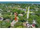 Aerial view of the home with lush trees surrounding it and a neighborhood street at 1108 Northside Dr, Ormond Beach, FL 32174