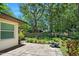 Paver patio in the backyard with lush green landscaping and mature trees at 1108 Northside Dr, Ormond Beach, FL 32174