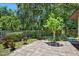 Charming backyard featuring a brick patio and lush landscaping at 1108 Northside Dr, Ormond Beach, FL 32174