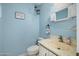Bathroom with blue walls, framed mirror, and a toilet at 1108 Northside Dr, Ormond Beach, FL 32174