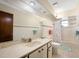 Bright bathroom features a large mirror, marble countertop, and neutral-colored tile at 1108 Northside Dr, Ormond Beach, FL 32174