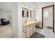 Bathroom featuring double sinks, tiled floors, and a doorway to a toilet and shower area at 1108 Northside Dr, Ormond Beach, FL 32174