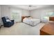 Serene bedroom with a bed, chair, dresser and soft, neutral tones at 1108 Northside Dr, Ormond Beach, FL 32174