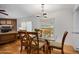 Charming dining area featuring hardwood floors, a modern table set, and a decorative lighting fixture at 1108 Northside Dr, Ormond Beach, FL 32174