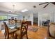 Dining room features a glass top table, hardwood floors, and access to the kitchen at 1108 Northside Dr, Ormond Beach, FL 32174