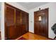 Entryway featuring wood floors, closet, and dark wood door with peek-a-boo window at 1108 Northside Dr, Ormond Beach, FL 32174