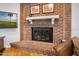 Close up of a brick fireplace with a white mantel and hearth at 1108 Northside Dr, Ormond Beach, FL 32174