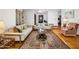 A large living room with hardwood floors, sofas, a decorative rug, and built in bookcase at 1108 Northside Dr, Ormond Beach, FL 32174