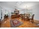 Bright living room showcasing hardwood floors, a brick fireplace, and elegant dining area at 1108 Northside Dr, Ormond Beach, FL 32174