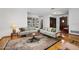 Spacious living room featuring hardwood floors, sofas, a decorative rug, and built in bookcase at 1108 Northside Dr, Ormond Beach, FL 32174