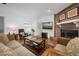 Bright living room with a brick fireplace, cozy seating, and ample natural light at 1108 Northside Dr, Ormond Beach, FL 32174
