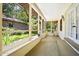 Enclosed patio with natural light, screens, and access to the outdoor greenery at 1108 Northside Dr, Ormond Beach, FL 32174