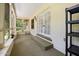Relaxing screened porch with tiled floors and a door leading to the outdoors at 1108 Northside Dr, Ormond Beach, FL 32174