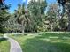 Beautiful backyard with lush trees and a sidewalk in the distance at 1162 Carmel Cir # 100, Casselberry, FL 32707
