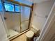 Bathroom showcases a glass-enclosed shower and a toilet with coordinated tile flooring at 1162 Carmel Cir # 100, Casselberry, FL 32707