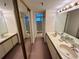 Bathroom featuring dual sinks, a large mirror, and a separate shower room at 1162 Carmel Cir # 100, Casselberry, FL 32707