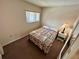 Cozy bedroom featuring neutral walls, a window with blinds, and patterned bedspread at 1162 Carmel Cir # 100, Casselberry, FL 32707