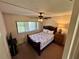 Cozy bedroom with a ceiling fan and natural light from a window, creating a relaxing atmosphere at 1162 Carmel Cir # 100, Casselberry, FL 32707