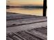 Closeup of an old wooden dock with a blurry view of the water at sunset at 1162 Carmel Cir # 100, Casselberry, FL 32707