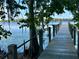 Long wooden dock extending over water, offering scenic views and access to waterfront activities at 1162 Carmel Cir # 100, Casselberry, FL 32707