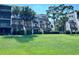 Exterior of a condo featuring green grass and palm trees at 1162 Carmel Cir # 100, Casselberry, FL 32707