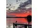Beautiful lake with a red sunset and a bird perched on a wooden dock at 1162 Carmel Cir # 100, Casselberry, FL 32707