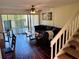 Bright living room featuring dark wood floors, and sliding glass doors with vertical blinds at 1162 Carmel Cir # 100, Casselberry, FL 32707