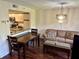 Spacious living room and dining area with modern light fixture and hardwood floors at 1162 Carmel Cir # 100, Casselberry, FL 32707