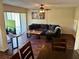Open floor plan living room with hardwood floors, ceiling fan and sliding glass door to patio at 1162 Carmel Cir # 100, Casselberry, FL 32707