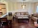 Well-lit living room with chandelier, hardwood floors, and comfortable seating at 1162 Carmel Cir # 100, Casselberry, FL 32707